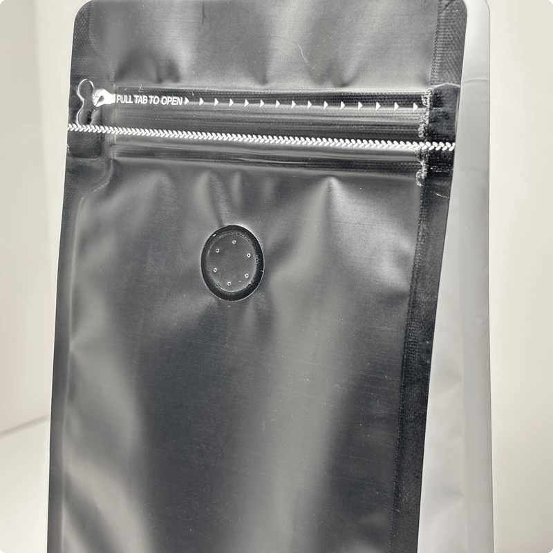 Close-up of one-way coffee degassing valve on flat bottom pouch from DSS Pack — freshness preservation feature for roasted coffee, allows CO2 release without oxygen ingress